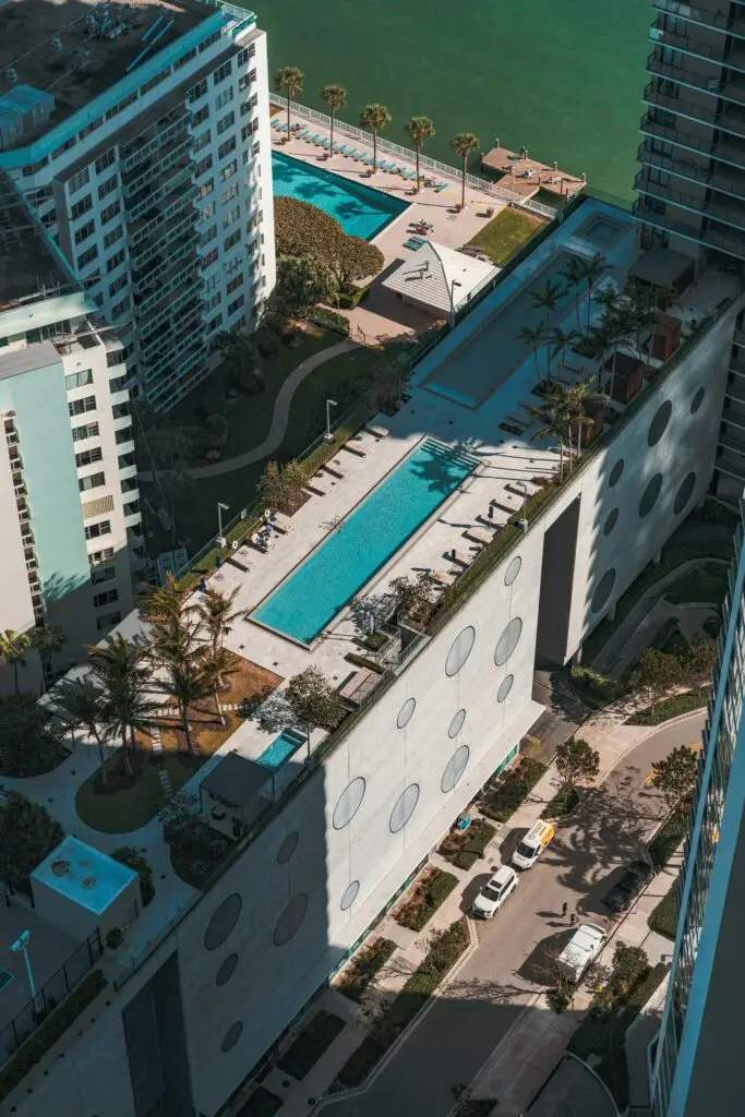 Luxurious Miami apartments with stunning pools and palm trees from above.